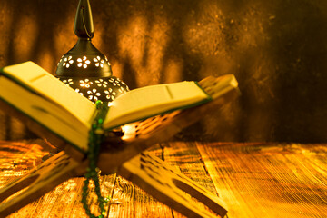 Holy Koran - Quran and rosary beads on the background with candle for Islamic concept. 