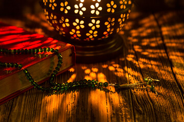 Holy Koran - Quran and rosary beads on the background with candle for Islamic concept. 