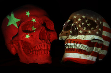 China and US face off. Opposing skulls with national emblem or flag patriotic symbol projected...