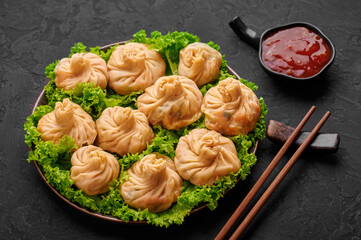 Veg Momos on black slate table top. Momos is the popular dish of indian, tibetan, chinese cuisines. Asian food. Vegetarian meal