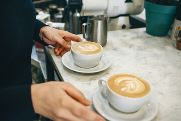 Barista gives coffee to the visitor