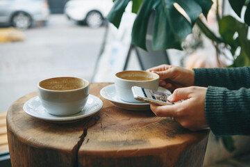 Girl with cell phone and coffee.