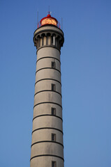 High lighthouse on the background of Purple sky, free space