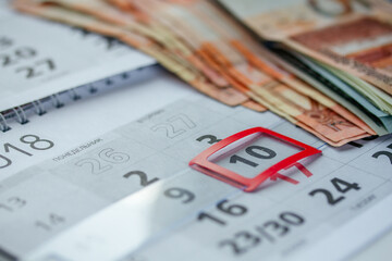 Banknotes of dollars on calendar sheets closeup