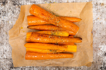 Baked season carrot sticks. Vegetarian healthy food. Flat lay, top view.