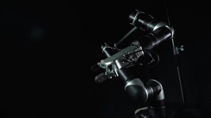 Futuristic robot arm moves randomly in space, system failure, mad robot on black background, dance of the robot manipulator.
