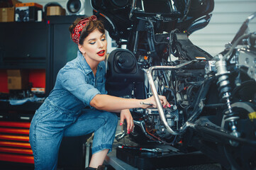 beautiful girl repairs a motorcycle in a workshop, pin-up style, service and sale