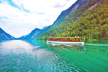 traditional tourist boat cruise on Konigssee lake with mountain view on background in Salzburg Germany