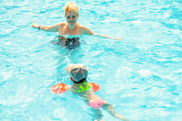 Mother and the daughter at pool, summer holidays