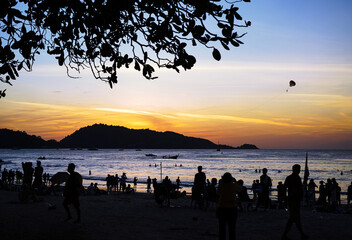 Sunset on a crowded beach in Phuket. Thailand