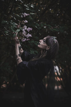 girl in a gothic gloomy image in a lilac