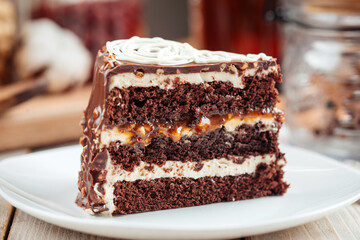 Slice of sweet chocolate sponge cake with nougat