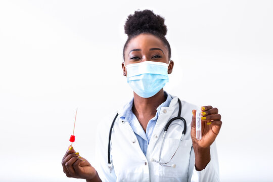 African American doctor testing for presence of coronavirus. Tube containing a swab sample that has tested positive for COVID-19.
