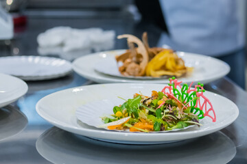 Delicious fresh exotic salad with natural ingredients for sale on white plate at cuisine of restaurant, cafe. Professional cooking, catering, cookery, gastronomy and food concept