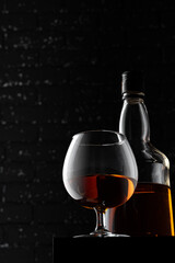 Whisky glass against dark black grunge wall