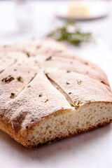 Homemade fresh baked Fougasse (French Bread) with thyme and olive oil on white background. Traditional Provencal dishes. Selective focus