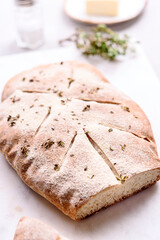 Homemade fresh baked Fougasse (French Bread) with thyme and olive oil on white background. Traditional Provencal dishes. Selective focus