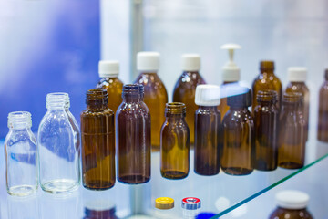 Pharma industry, science, medicine, experiment and healthcare concept. Medical empty glass bottles in showcase at pharmaceutical exhibition, pharmacy laboratory