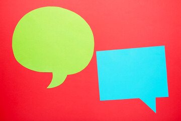 Dialog - two blank speech bubbles on red backgrounnd