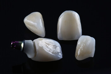 Fototapeta na wymiar dental crown and one zirconium abutment with orthopedic components on a black background
