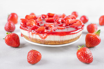 cheesecake with strawberry and fresh berries on gray table and white background