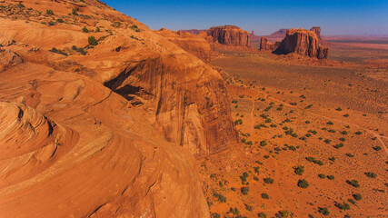 Bird's eye scenery view of unique geological formation of Arizona landmark. Monument Valley rocks one of the National symbols of the United States of America. Sandy desert landscape with mountains