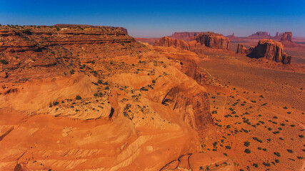Fototapeta na wymiar Bird's eye scenery view of unique geological formation of Arizona landmark. Monument Valley rocks one of the National symbols of the United States of America. Sandy desert landscape with mountains