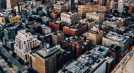 Aerial view from helicopter sightseeing tour around Manhattan downtown district. Scenery bird's eye view with blocks of buildings leaving horizon. Metropolis with developed city urban infrastructure