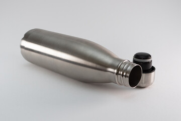 Metal flask, bottle for preservation of a hot or cold liquid on a white background.