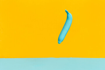 painted blue banana on a yellow background. creativity design concept