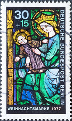 GERMANY, Berlin - CIRCA 1977: a postage stamp from Germany, Berlin showing the Christmas mask 1977. Lead stained glass. Mari and Christ Child