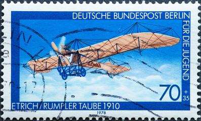 GERMANY, Berlin - CIRCA 1978: a postage stamp from Germany, Berlin showing a historic motor plane with a propeller Text: Etrich Rumpler Taube 1910