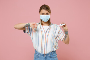 Upset young woman in casual striped shirt sterile face mask isolated on pink background. Epidemic...