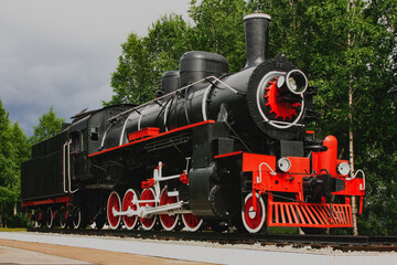 Fototapeta premium Old classical black and red vintage steam locomotive, locomotive monument in Russia Siberia.