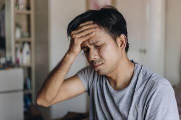 Young asian men are stressed and headache