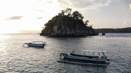 Fototapeta na wymiar Indonesian traditional boats with outriggers (Bangka) at harbor in sunset.