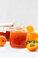 Summer Apricot Jam on Wooden Background. Selective focus.