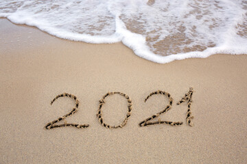 Fototapeta premium Year 2021 written at the caribbean sand beach with sea wave .