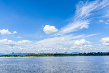 River and cirrus, cumulus clouds on blue sky background.