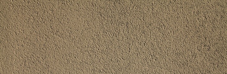 Cement textured coating, texture, background. Structural plaster, rough, uneven surface in brown or gray color. Modern exterior cladding of multi-story buildings