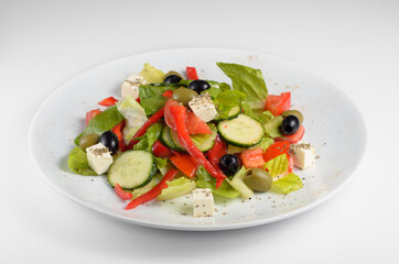 Neapolitan mix - vegetarian tasty and healthy salad of Italian cuisine with bell pepper, salad mix, olive oil, tomato, olives, cucumber, olives, feta cheese and Balsamico sauce.