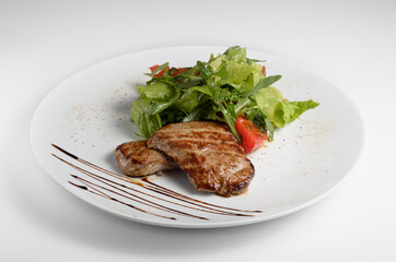 Veal medallions with grilled tomatoes. For use in menu design and online delivery service. Can be used in a cookbook.