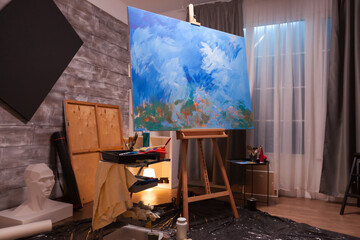 Interior of painting studio with wooden easel and blank canvas. Modern artwork paint on canvas, creative, contemporary and successful fine art artist drawing masterpiece