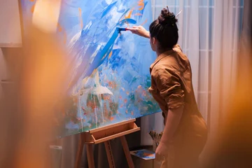 Fotobehang Schilderij Motivated young painter making a masterpiece in art studio. Modern artwork paint on canvas, creative, contemporary and successful fine art artist drawing masterpiece  © DC Studio