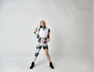 beautiful girl in robot clothes posing with silver revolvers