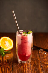 Tasty blackberry smoothie with mint and fresh berries in glasses on wooden background