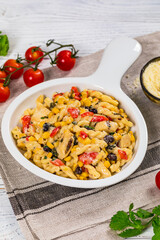 Cheesy Grilled Chicken Alfredo Pasta Florentine with Black Beans and Corn. Selective focus.