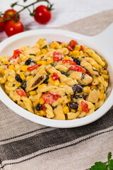 Cheesy Grilled Chicken Alfredo Pasta Florentine with Black Beans and Corn. Selective focus.