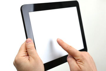 Close up of male hand holding electronic pad PC with white display