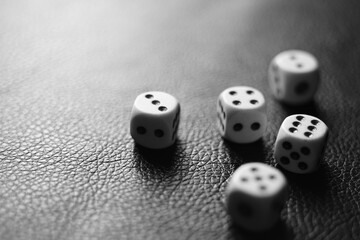 Several dice on the table. Black and white photo